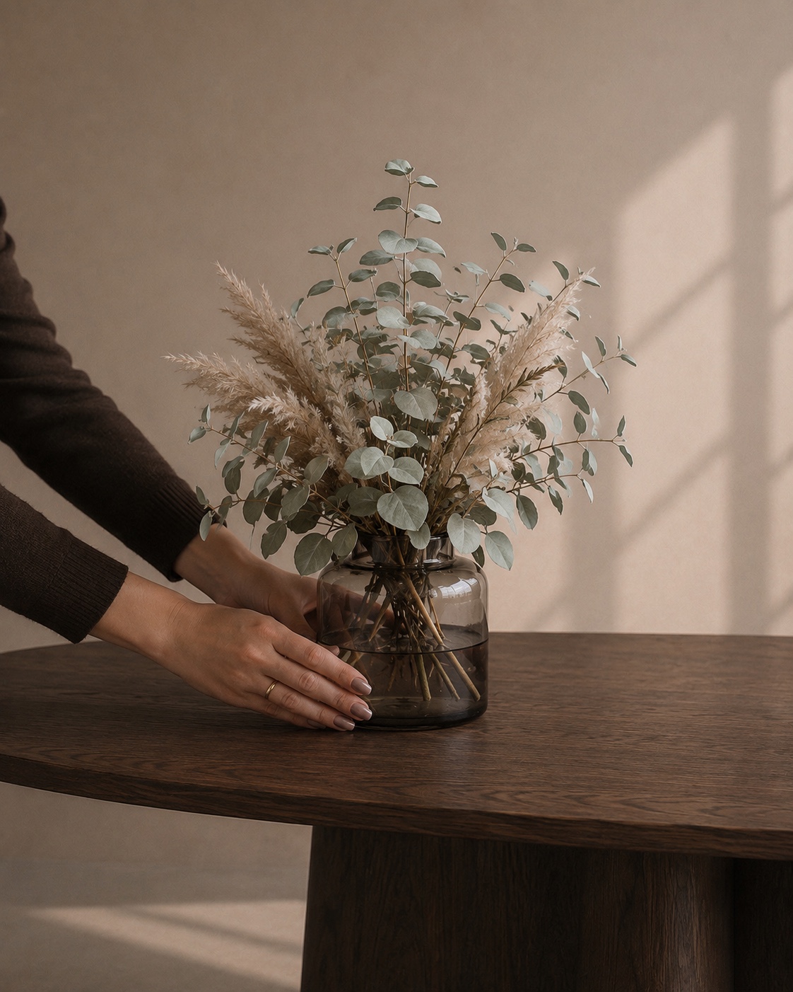Dark wood table styled with a floral arrangement