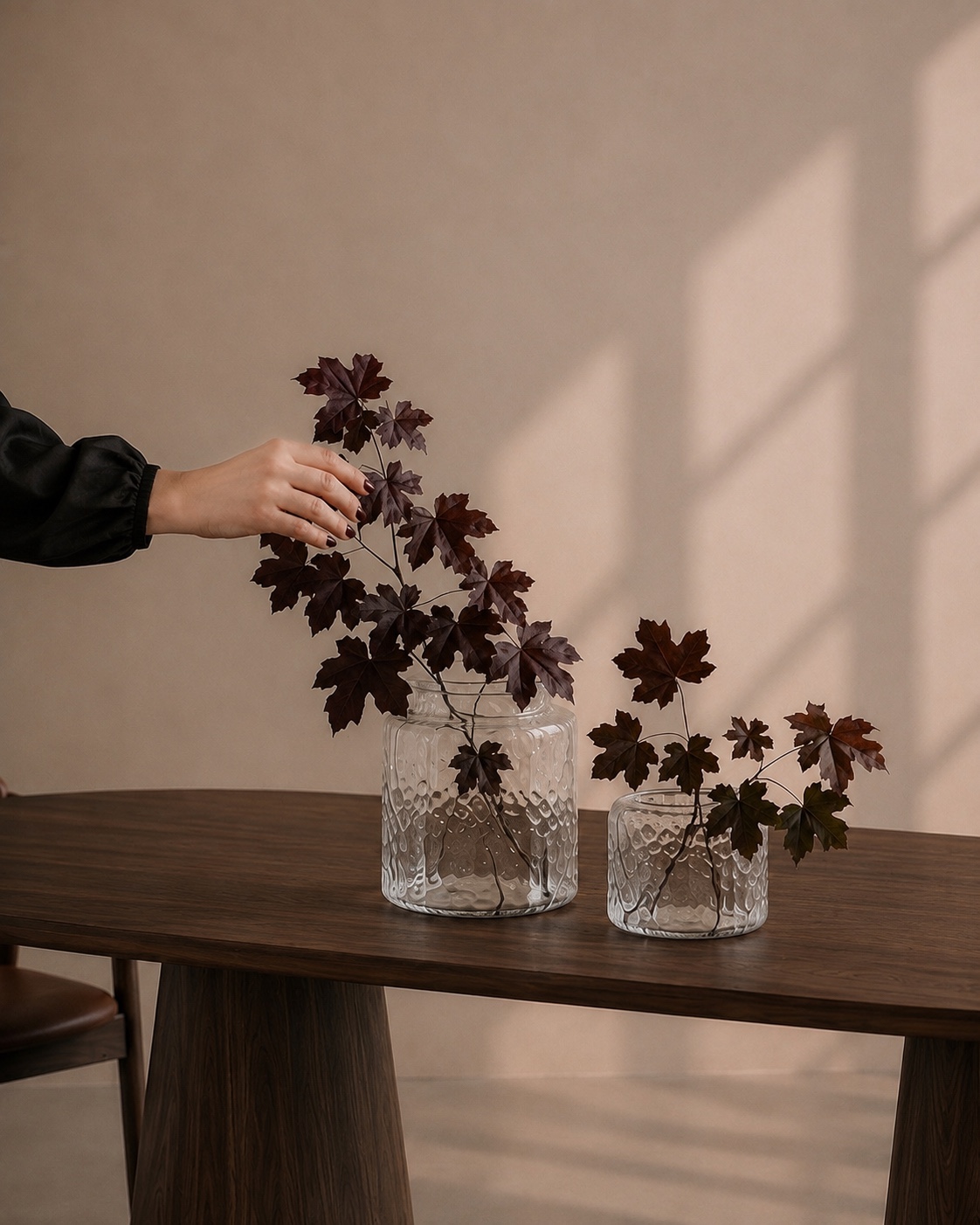 Dark wood table styled with glass vases